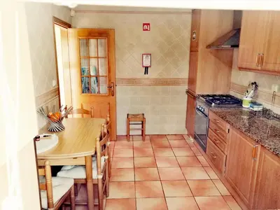 a kitchen with wooden cabinets and a stainless steel refrigerator at Beautiful Vila Rafaella, walk distance to beaches in Albufeira