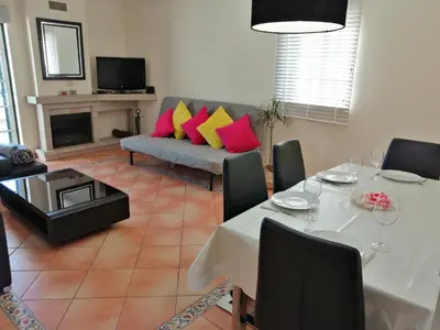 a living room with a table and a couch at Beautiful Vila Rafaella, walk distance to beaches in Albufeira