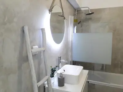 a bathroom with a white sink and a mirror at Atlantico 8- Vista Mar, Ar-Condicionado, 80mt Praia, Wifi in Quarteira