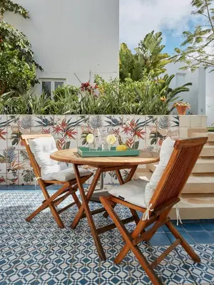 a wooden table and two chairs on a patio at Casa Apollo Guesthouse in Faro