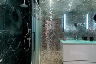 a bathroom with a shower with a sink and a mirror at Akisol Quarteira Gun in Quarteira