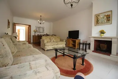 a living room with couches and a tv and a fireplace at 4 bedroom town house Vale de Parra, close to Gale AT22 in Guia