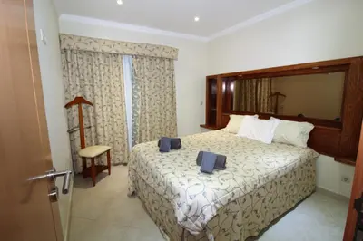 a hotel room with a bed and a mirror at Beach Waves - Albufeira in Albufeira