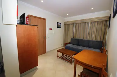 a living room with a couch and a table at Beach Waves - Albufeira in Albufeira