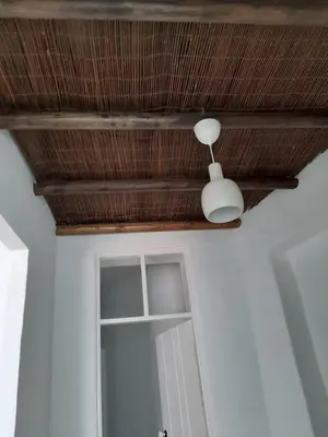 a ceiling with a white light and a door at Traditional House in Historical Center of Faro in Faro