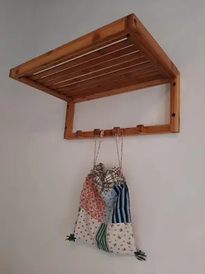 a purse hanging on a wall with a wooden shelf at Traditional House in Historical Center of Faro in Faro