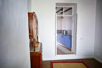 a kitchen with blue cabinets and an open door at Traditional House in Historical Center of Faro in Faro