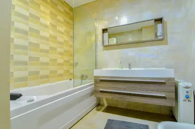 a bathroom with a sink and a tub and a toilet at Stunning Villa with Pool in Albufeira