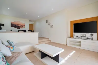 a living room with a bed and a tv at Stunning Villa with Pool in Albufeira