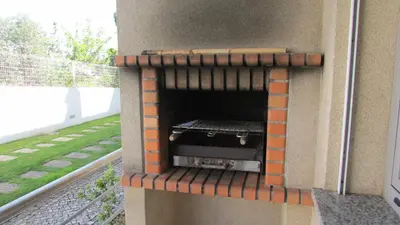 an outdoor pizza oven in the side of a house at Pomba Branca (4-6 per.) Piscina, 500m Praia in Albufeira