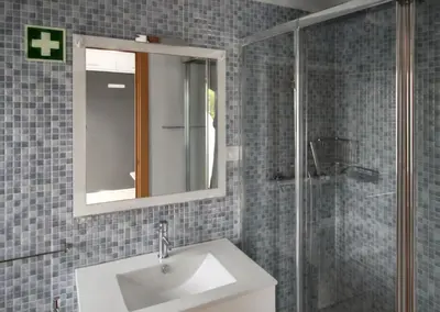a bathroom with a sink and a mirror and a shower at Comfortable studio in Albufeira - 20 m² - Pleasant balcony in Albufeira