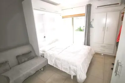 a small bedroom with a bed and a couch at Comfortable studio in Albufeira - 20 m² - Pleasant balcony in Albufeira