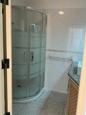 a shower in a bathroom with a glass door at A CASINHA - Pateo Aldeia in Albufeira