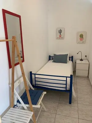 a bedroom with a bed and a ladder and a mirror at A CASINHA - Pateo Aldeia in Albufeira