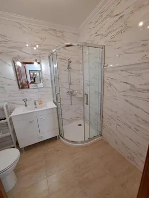 a bathroom with a shower and a toilet and a sink at Apartamentos Roja Sol in Albufeira