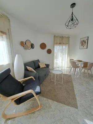 a living room with a couch and a table at Apartamentos Roja Sol in Albufeira