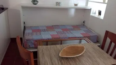 a small room with a table and a bed at Casal das Alfarrobeiras, 7 in Vilamoura