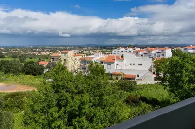 a balcony with plants on a white building at Hillside Studio with Sea View & Fibre Internet in Albufeira