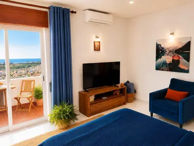 a table and chairs on a balcony with a view at Hillside Studio with Sea View & Fibre Internet in Albufeira