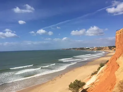 a group of people walking on a beach at CASA GRAZINA in Boliqueime