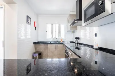 a kitchen with a sink and a counter top at Vista Mar e Terra in Albufeira