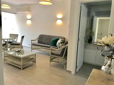 a living room with a couch and chairs and a table at B2 Marina Vilamoura Apartment in Quarteira