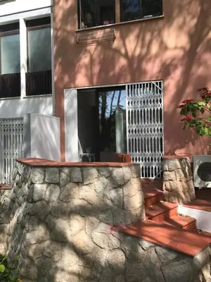 a house with a stone wall and a fence at B2 Marina Vilamoura Apartment in Quarteira