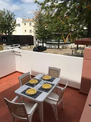 a table with plates of food on a balcony at B2 Marina Vilamoura Apartment in Quarteira