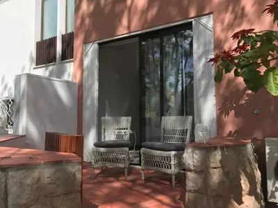a patio with two wicker chairs and a table at B2 Marina Vilamoura Apartment in Quarteira