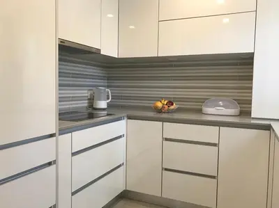 a kitchen with white cabinets and a bowl of fruit on the counter at B2 Marina Vilamoura Apartment in Quarteira