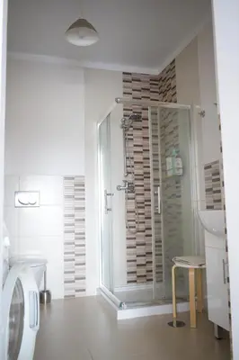 a bathroom with a shower and a toilet and a sink at Estúdio-Gambelas in Faro
