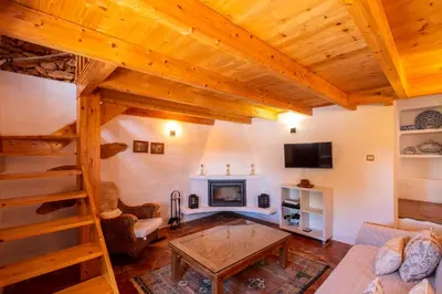 a living room with wooden ceilings and a fireplace at Villa Monte Algarvio - Private Heated Pool - wifi in Tunes