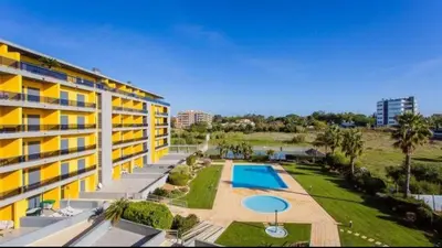 an aerial view of a building with a swimming pool at Parque Atlântico com Vista Mar in Quarteira