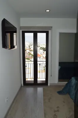 a room with a door with a view of a city at magnifico apartamento in Albufeira