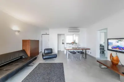 a living room with a couch and a table at Beach Design House Sao Rafael in Albufeira