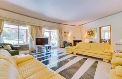 a living room with yellow furniture and a flat screen tv at OnJ Vilamoura in Quarteira