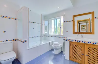 a bathroom with a tub and a toilet and a sink at OnJ Vilamoura in Quarteira