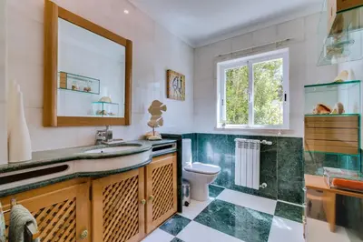 a bathroom with a sink and a toilet at OnJ Vilamoura in Quarteira