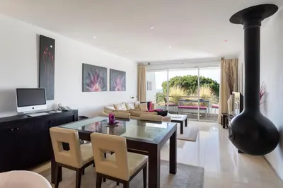 a living room with a table and chairs at Romy in Vale do Lobo