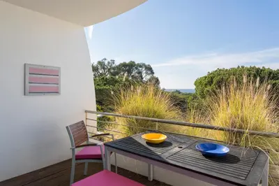 a table with two bowls on it on a balcony at Romy in Vale do Lobo