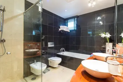 a bathroom with a toilet and a sink and a shower at Romy in Vale do Lobo