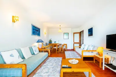 a living room with a couch and a table at WHome | Vilamoura Sunny Apartment in Quarteira