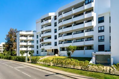 an apartment building on the side of a street at WHome | Vilamoura Sunny Apartment in Quarteira