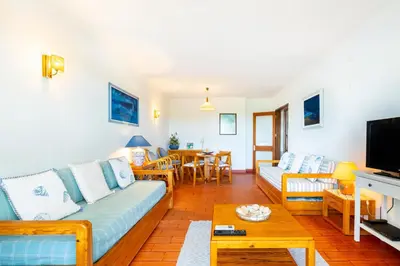 a living room with a couch and a table at WHome | Vilamoura Sunny Apartment in Quarteira