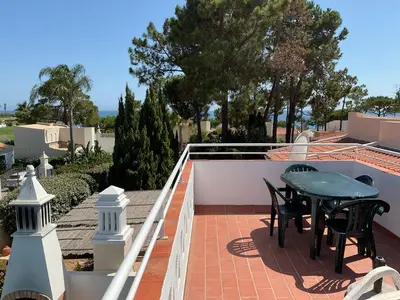 a patio with a table and chairs on a roof at Casa Nicho in Vale do Lobo