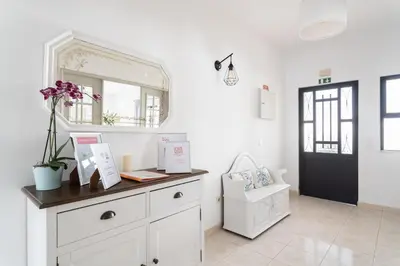a room with a dresser with a mirror and a chair at Monte Madalena in Adega