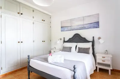a bedroom with a bed and white cabinets at Monte Madalena in Adega
