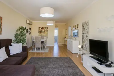 a living room with a couch and a tv at FLH Falésia Flat with Pool in Vilamoura
