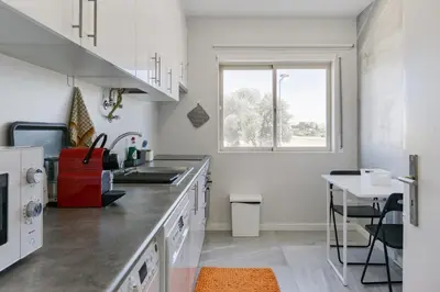 a kitchen with a counter and a sink and a window at FLH Falésia Flat with Pool in Vilamoura