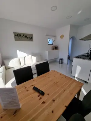 a living room with a wooden table and a couch at AAA Apartments in Albufeira